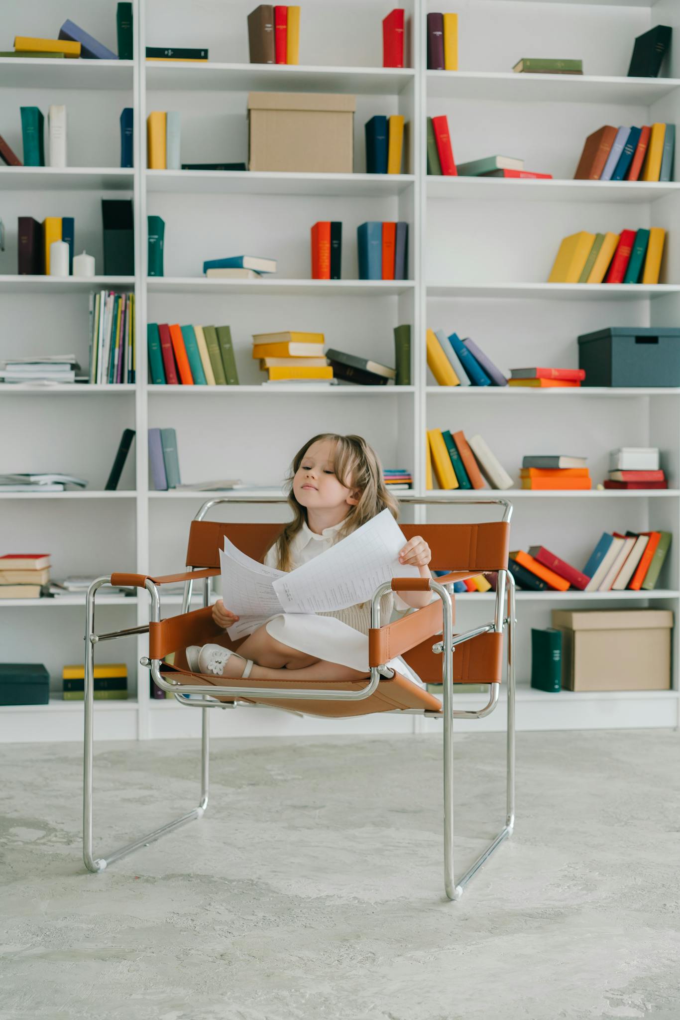 A Girl in White Dress Sitting on a Chair