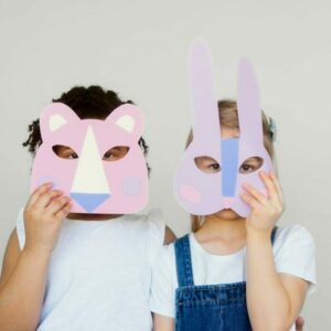 Two Kids Covering Their Faces With a Cutout Animal Mask
